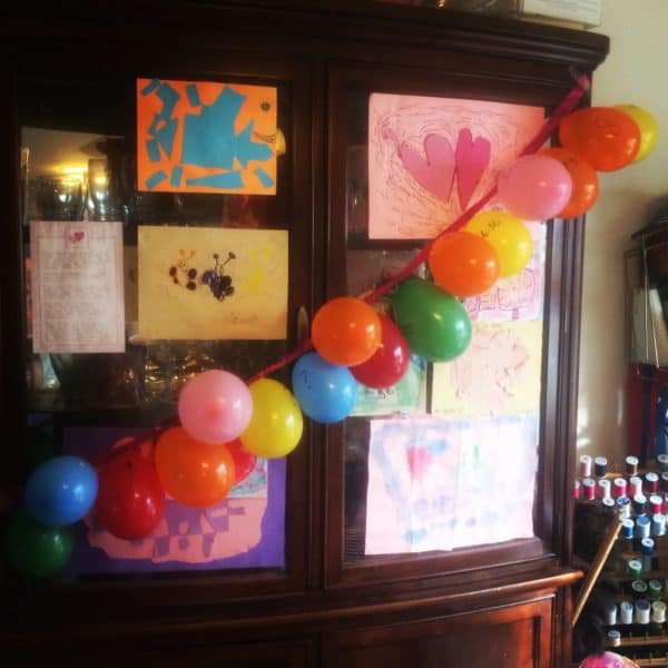 A string of balloons across a cabinet