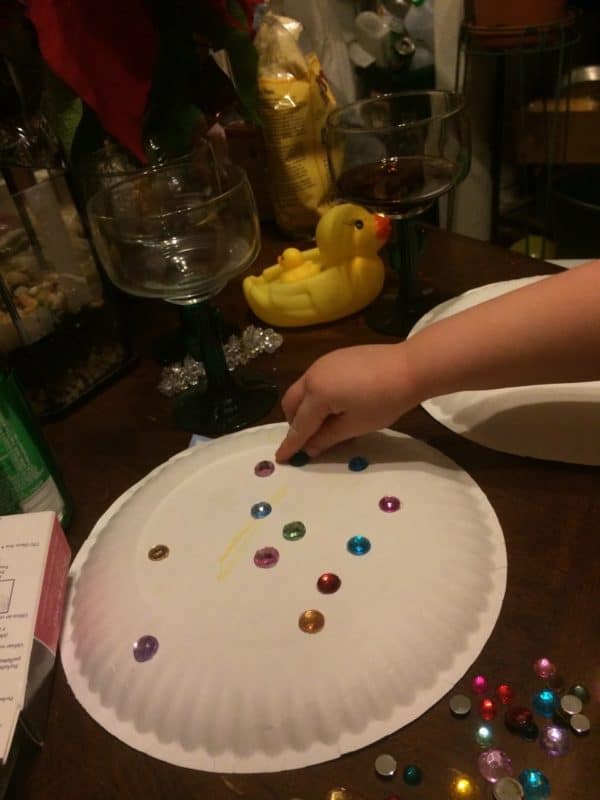 Glue sequins or jewels onto the paper plates