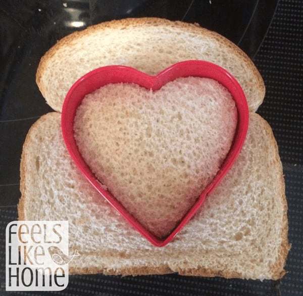 a piece of bread with a heart-shaped cookie cutter