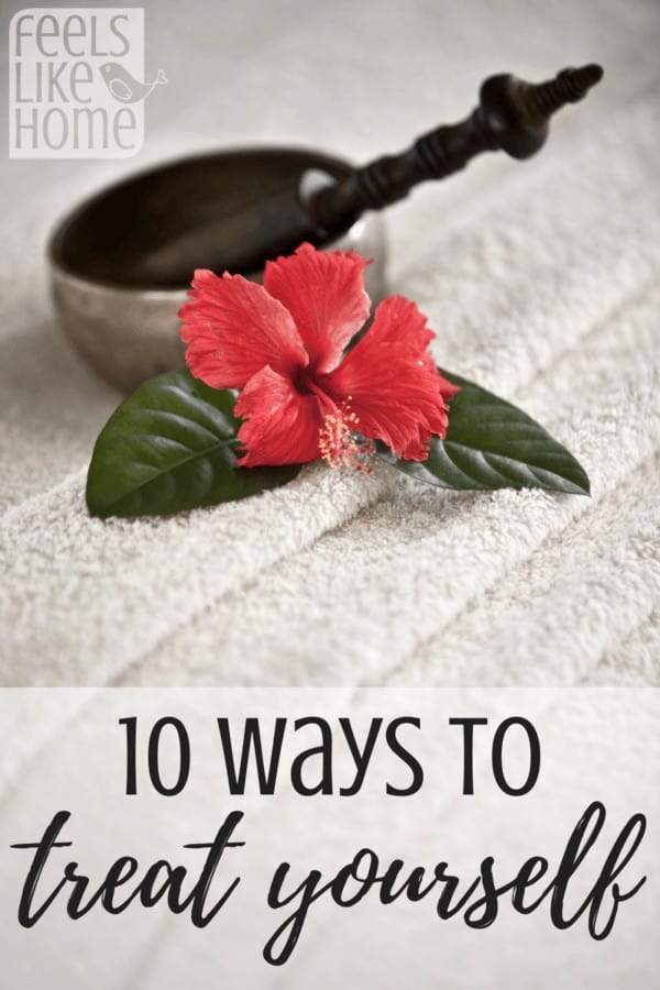 A red hibiscus flower on top of a plush bath towel