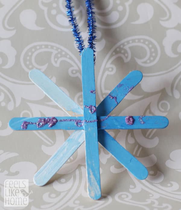 A blue snowflake made of popsicle sticks