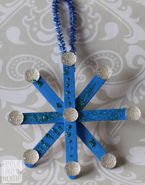 A blue Snowflake made of popsicle sticks