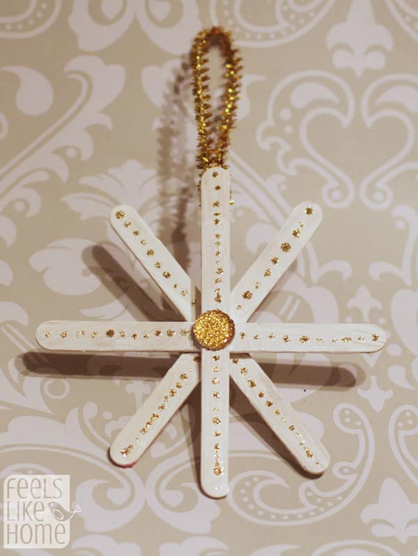 A gold snowflake made of popsicle sticks