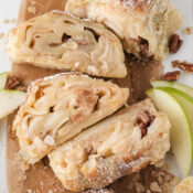 three slices of apple strudel made with puff pastry, cut to show the apple filling