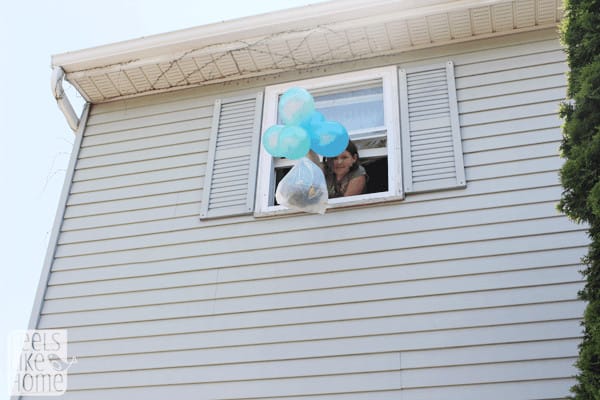 a little girl dropping an egg package from a second floor window