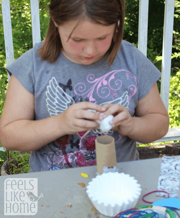 a little girl building with scrap materials