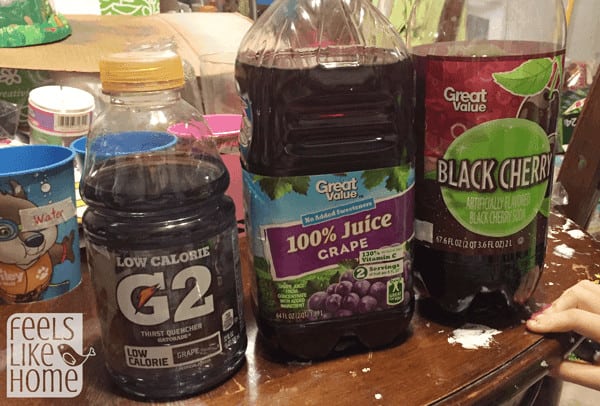 a line of drinks including purple gatorade, grape juice, & black cherry soda