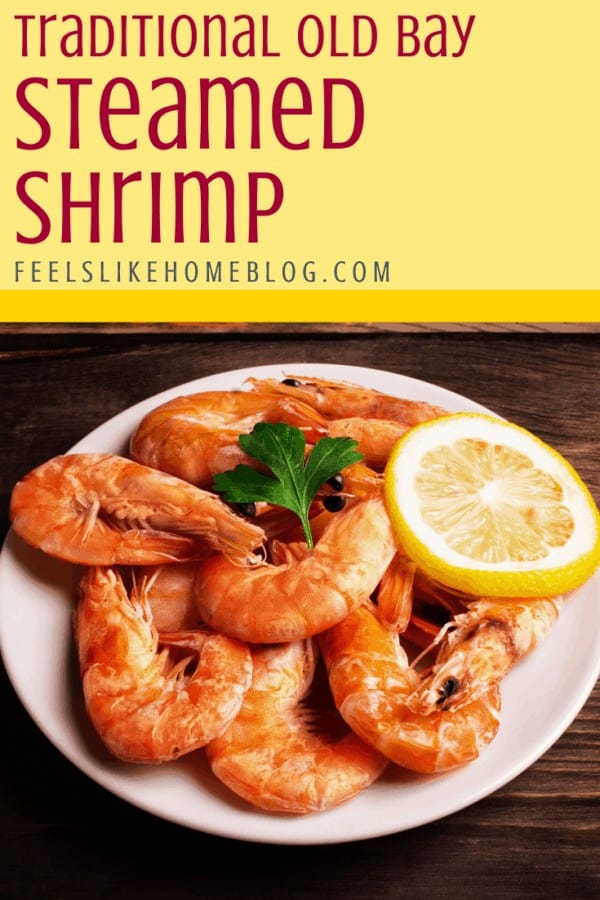 A plate of food on a table, with Shrimp and lemon