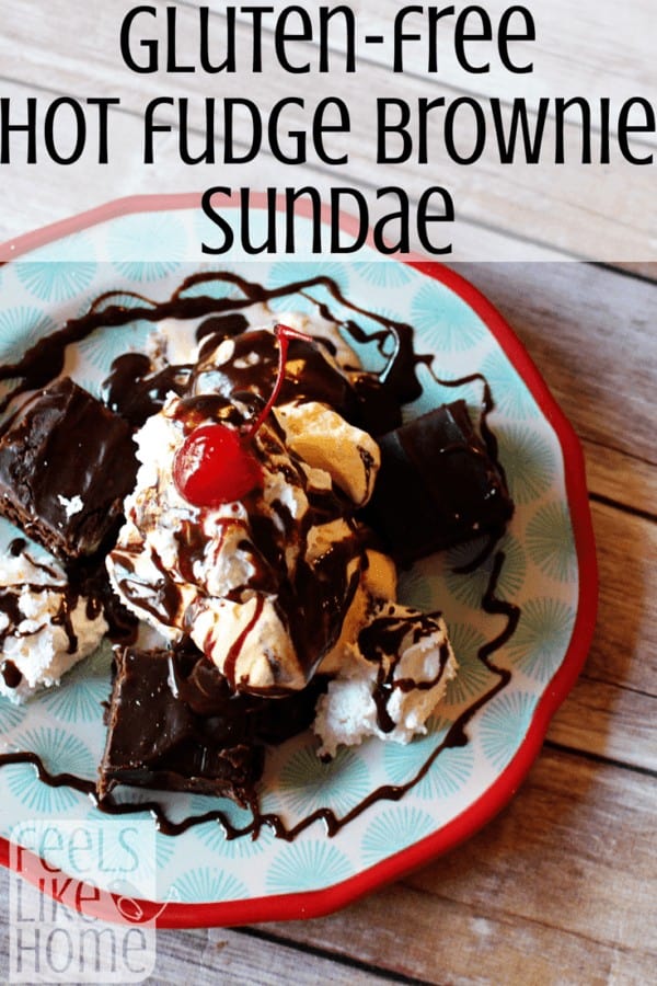 A brownie sundae on a plate with hot fudge