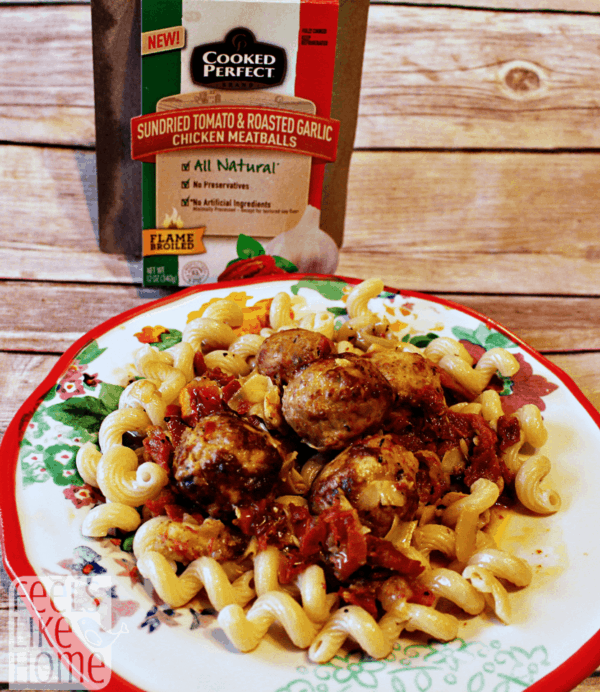 A plate of food on a table, with Meatballs and sun-dried tomatoes