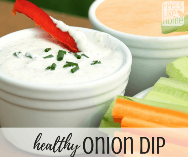 A bowl of onion dip with celery and carrots