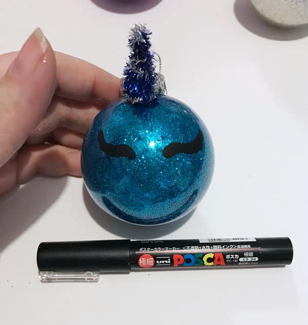 Use a paint pen to make eyes on the ornament