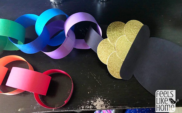 a paper pot of gold with a rainbow paper chain