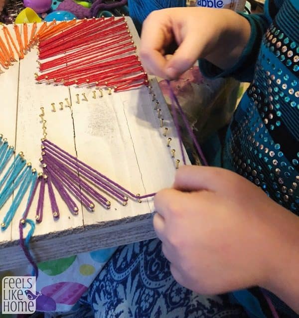 8 year old making DIY string art