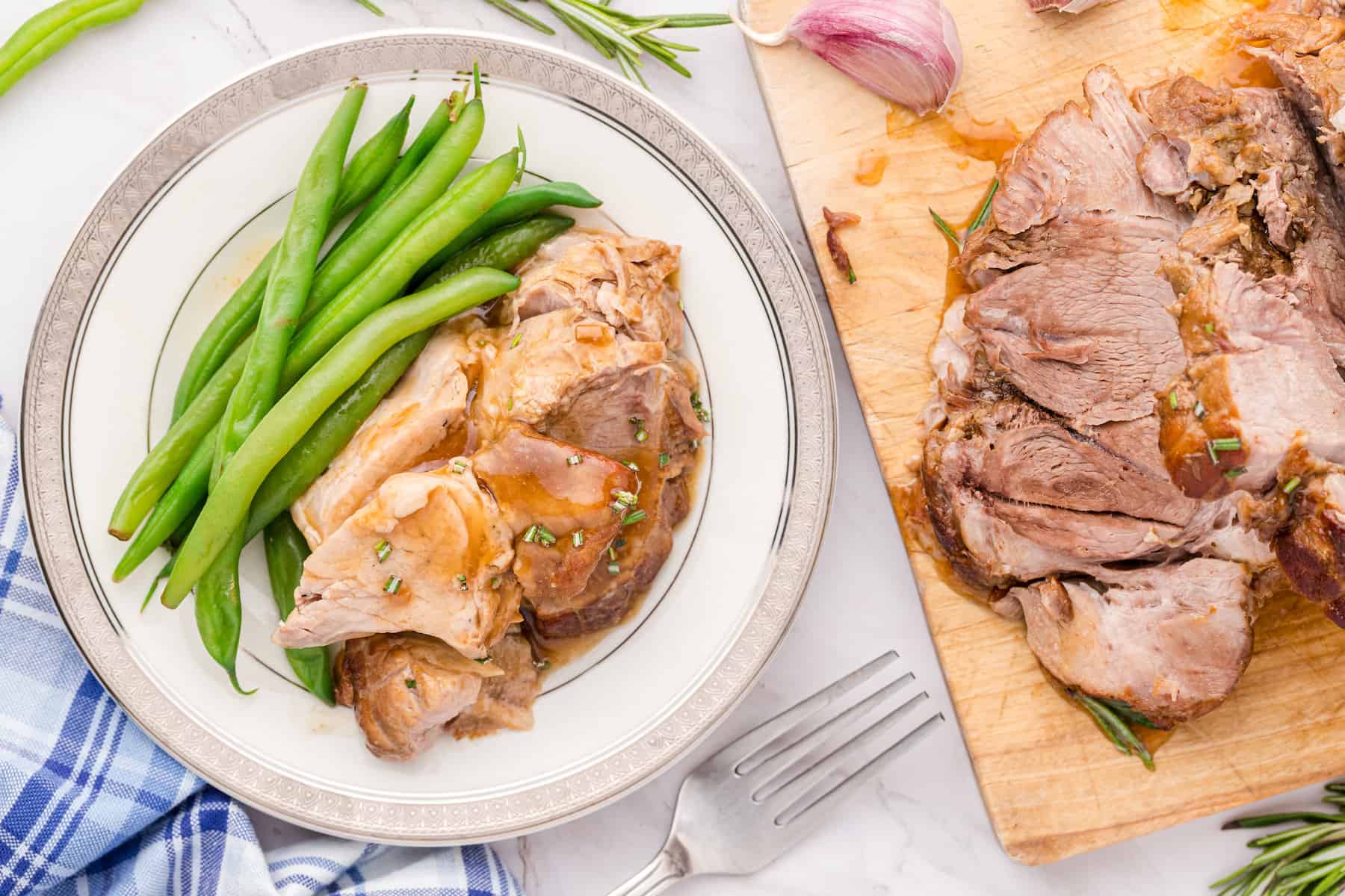 Sweet Balsamic Pork Roast sliced on a plate with green beans