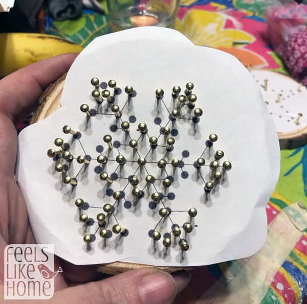 A snowflake ornament with the nails all in