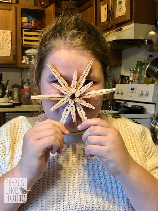 A person a clothespin snowflake