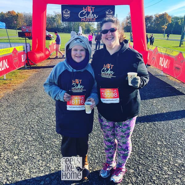 Tara Ziegmont and her daughter posing for the camera at a 5K race