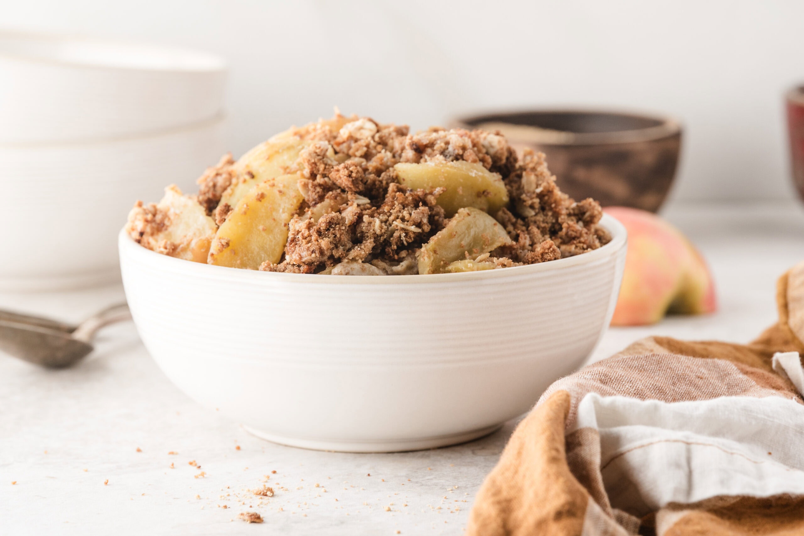 warm apple crisp piled high in a bowl