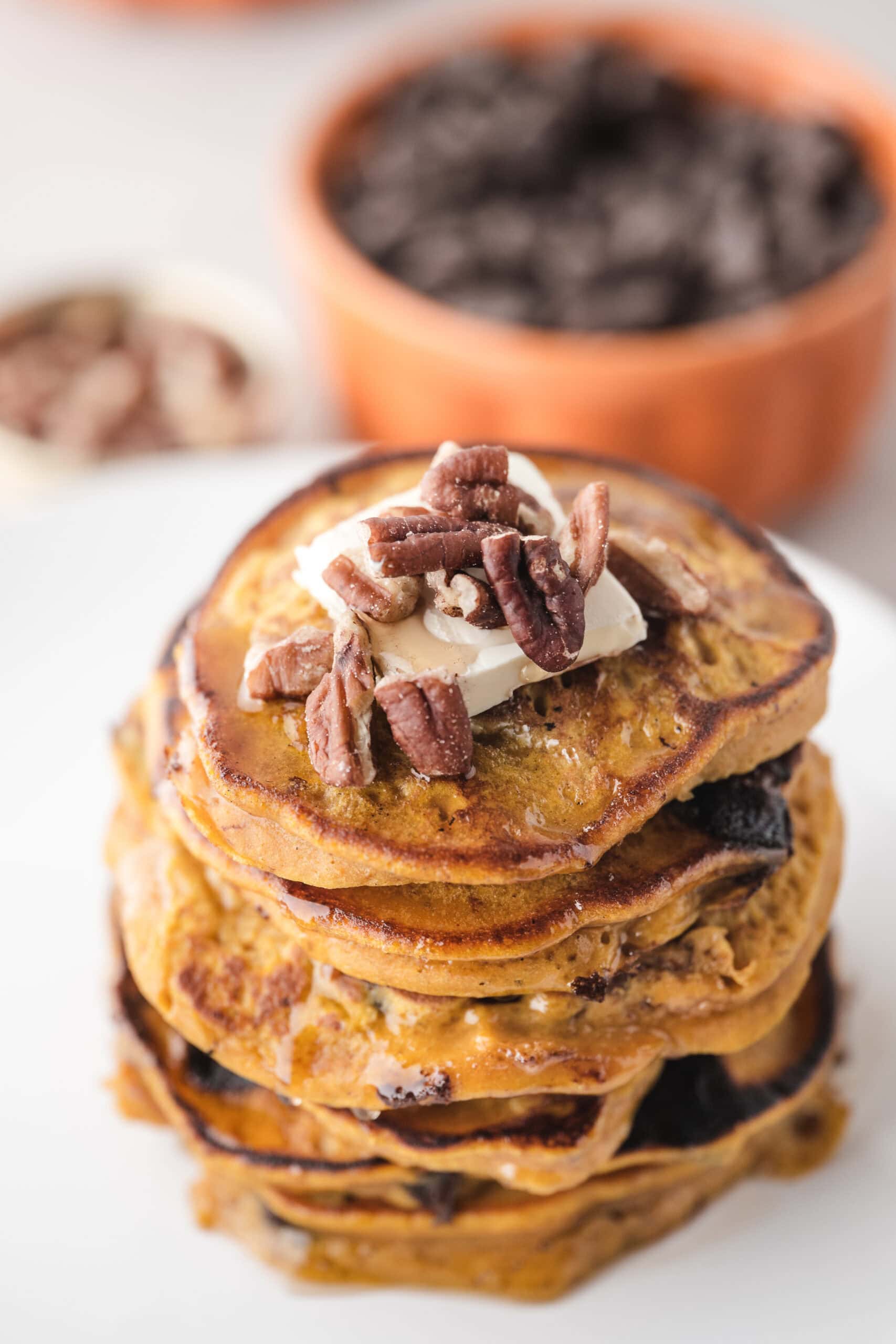 Pumpkin Spice Pancakes piled high with butter, pecans
