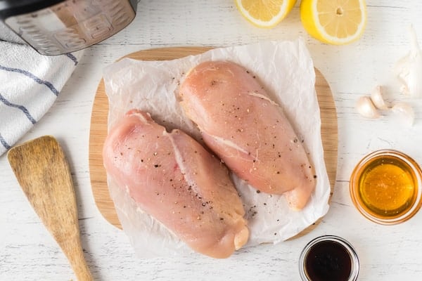 two chicken breasts on parchment paper