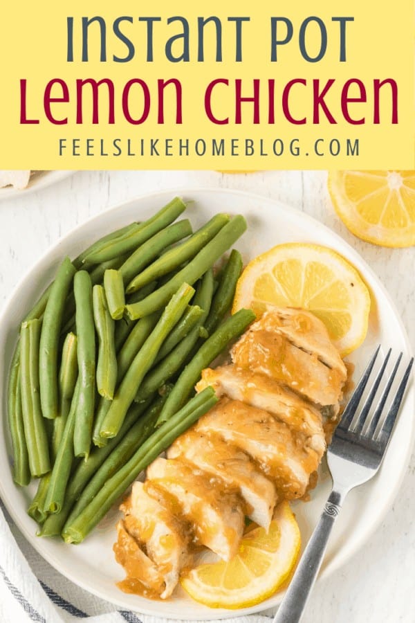 A plate of Chicken and Lemon on a table with a fork and green beans