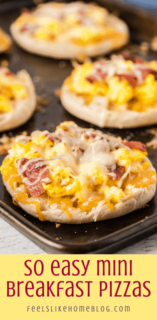 several mini pizzas on a baking sheet with eggs, bacon, and English muffins