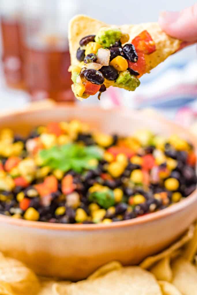 one chip with black bean and corn salsa on it