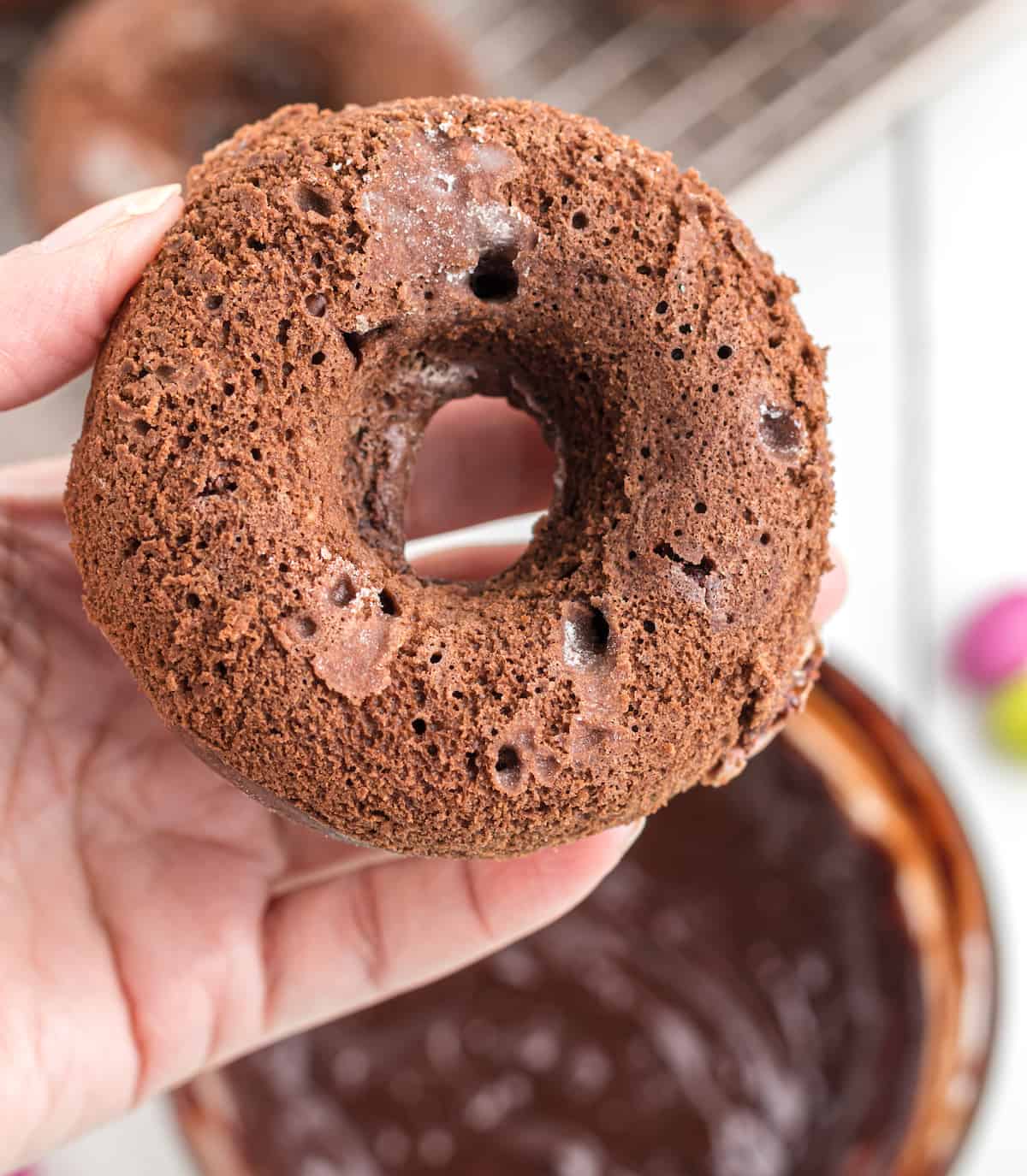 chocolate donut held in a hand