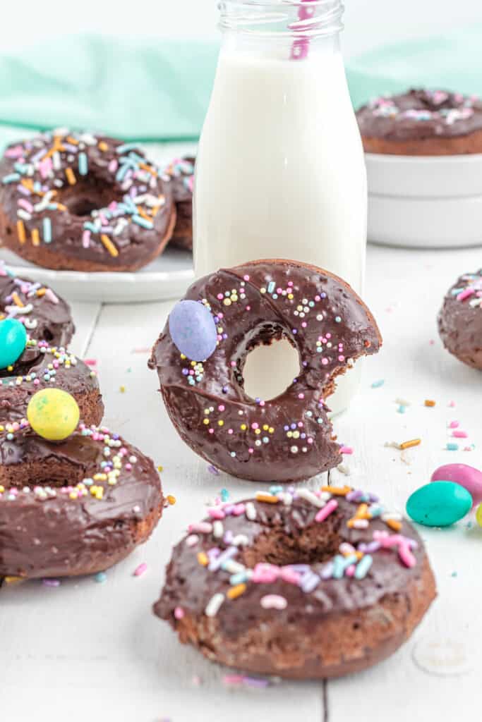 a chocolate frosted chocolate donut with milk