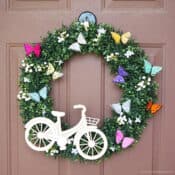 cute butterfly wreath with a white bicycle attached