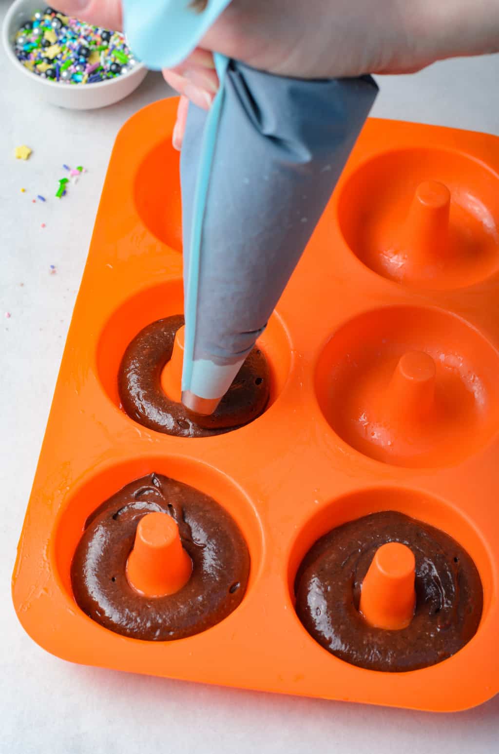 pipe the double chocolate batter into the donut pans