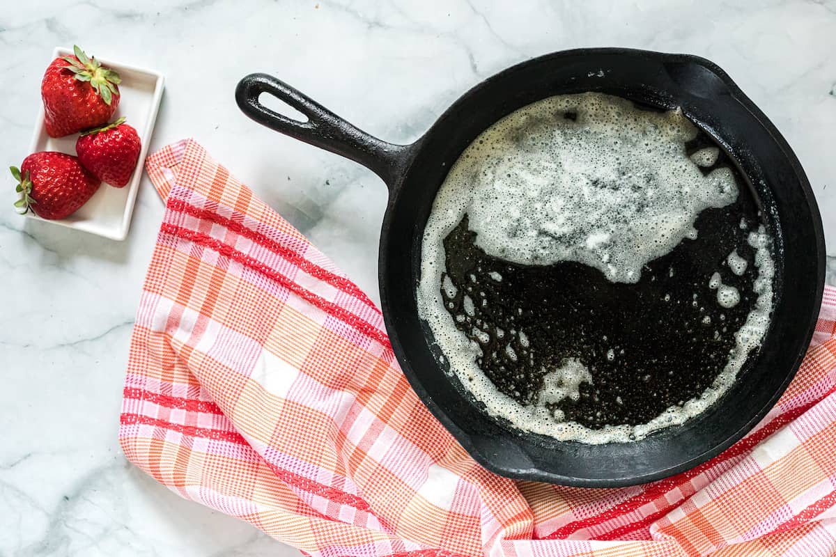 cast iron skillet with melted butter