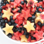 red, white, and blue fruit salad with watermelon and peach stars and blueberries