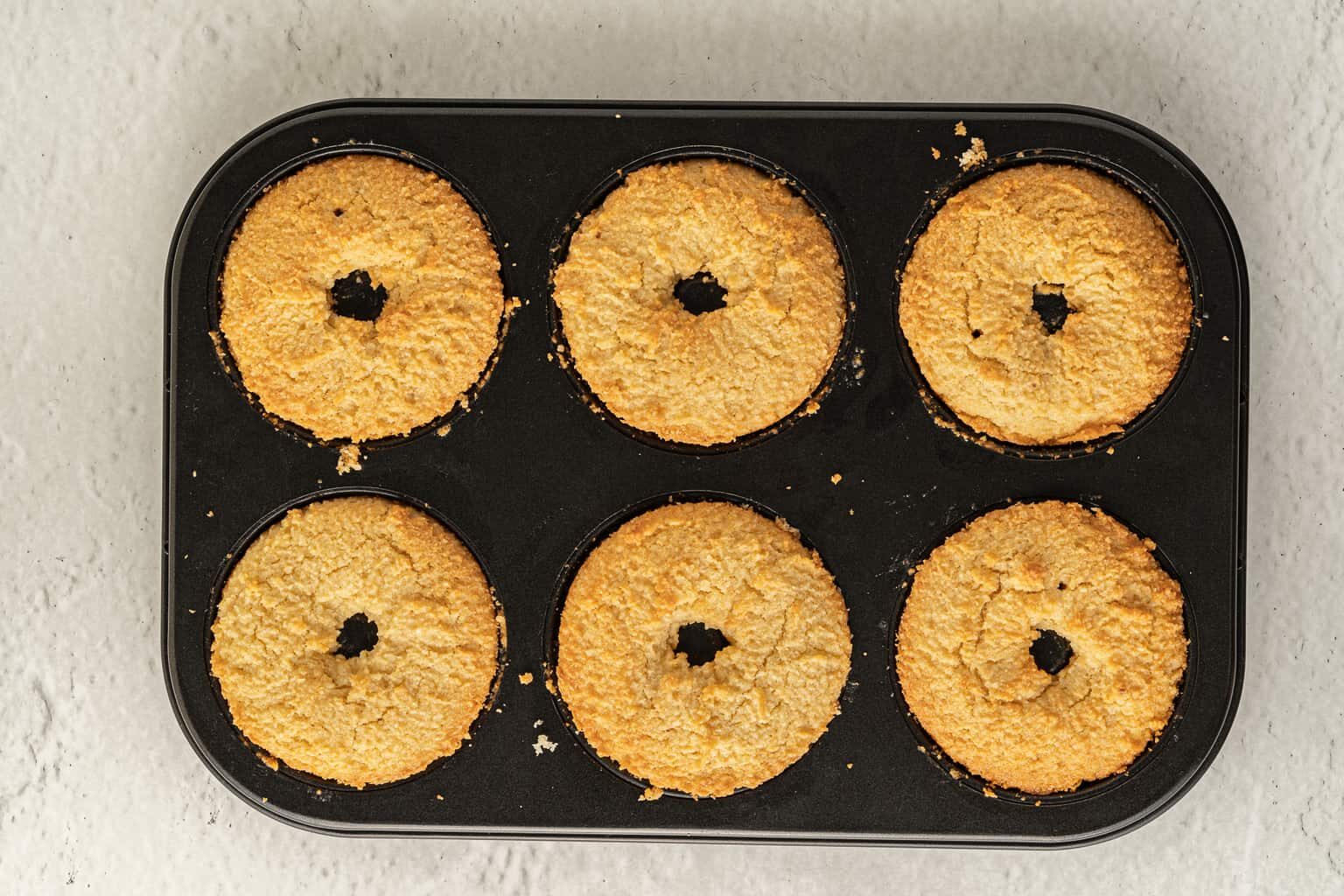 almond flour donuts in a baking pan