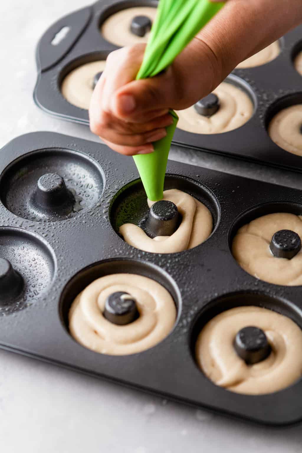 pipe the donut batter into the donut pan