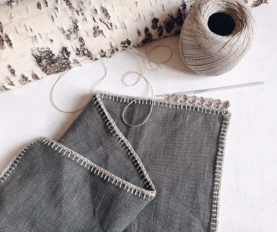 a crocheted edge on a gray blanket