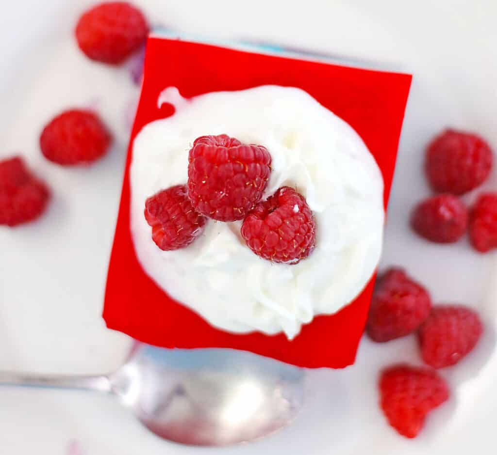 layered jello from the top with whipped cream and raspberries