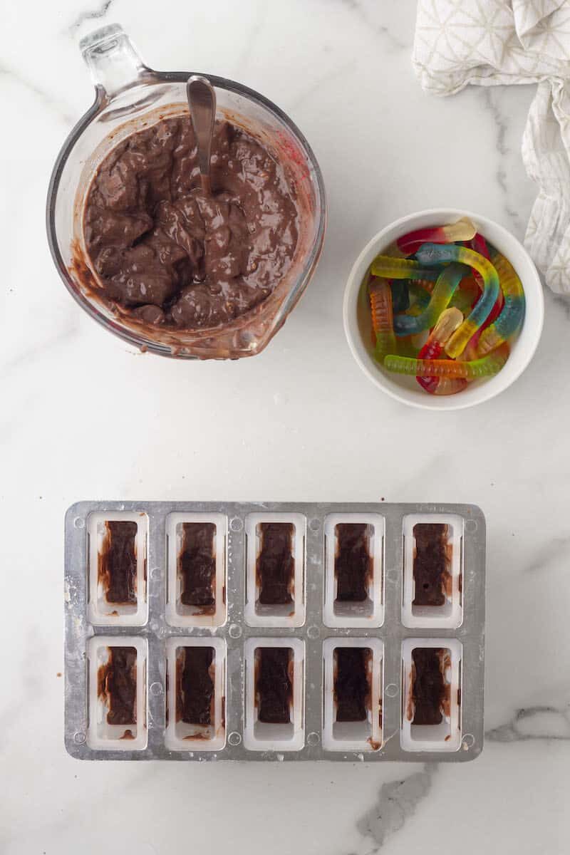 fill the popsicle molds halfway with chocolate pudding
