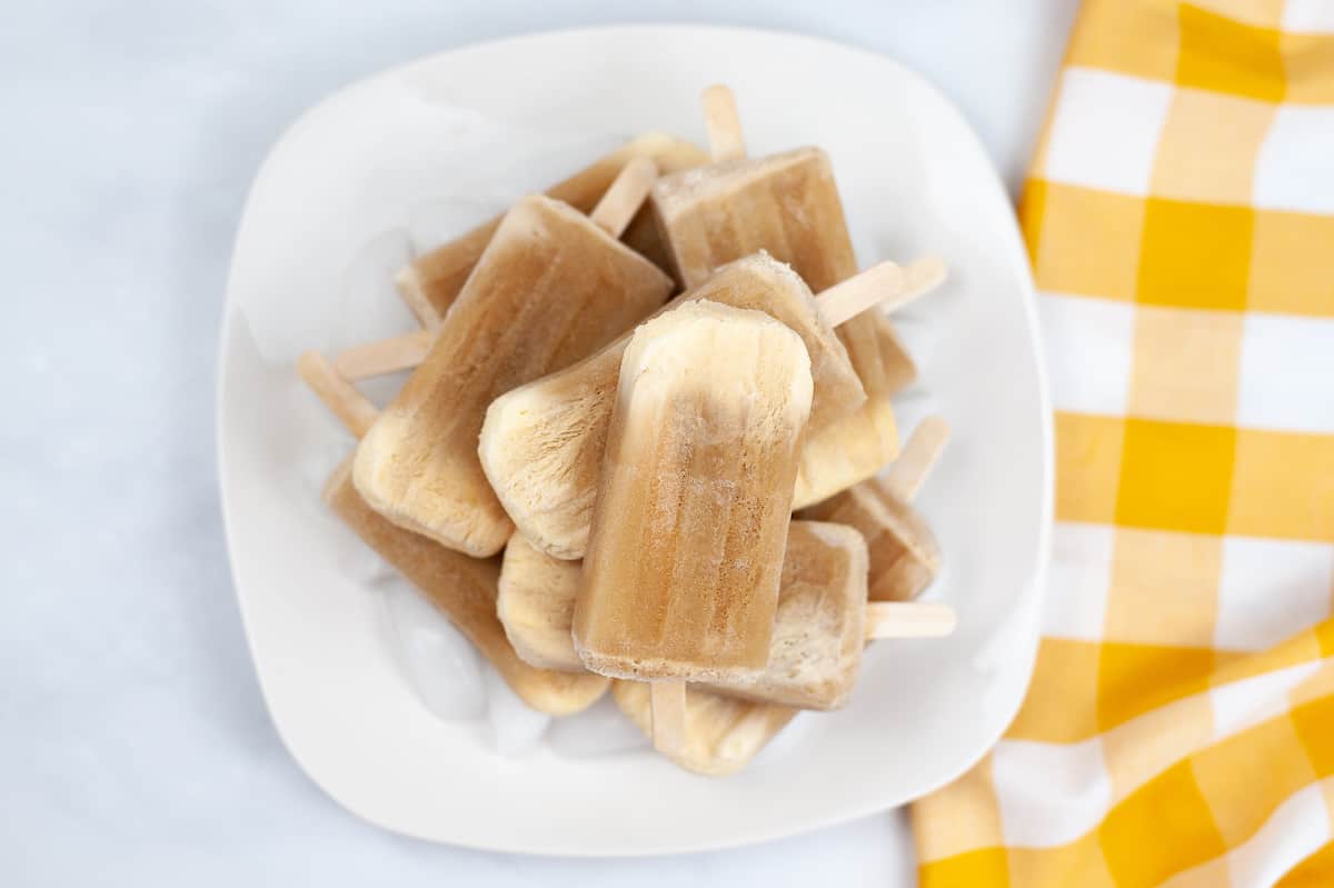 a pile of root beer float popsicles on a white plate