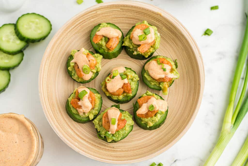 shrimp avocado cucumber bites topped with cajun remoulade sauce and green onions