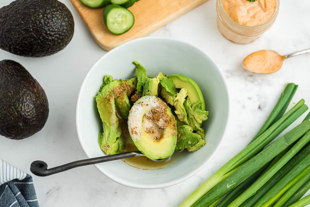 spices on top of avocado in a white bowl