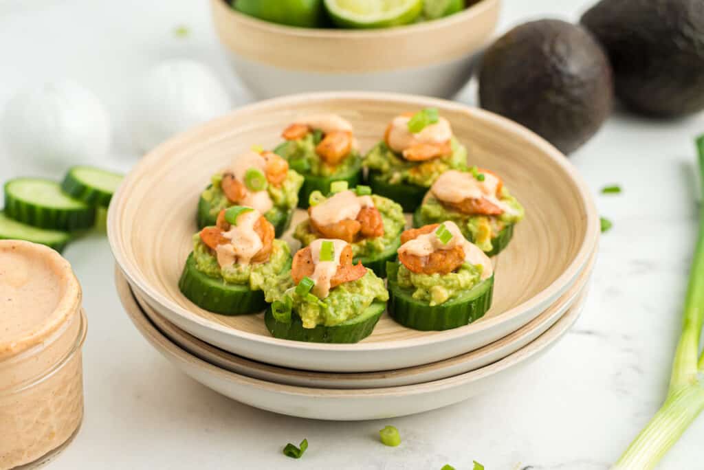 shrimp avocado cucumber bites topped with cajun remoulade sauce and green onions