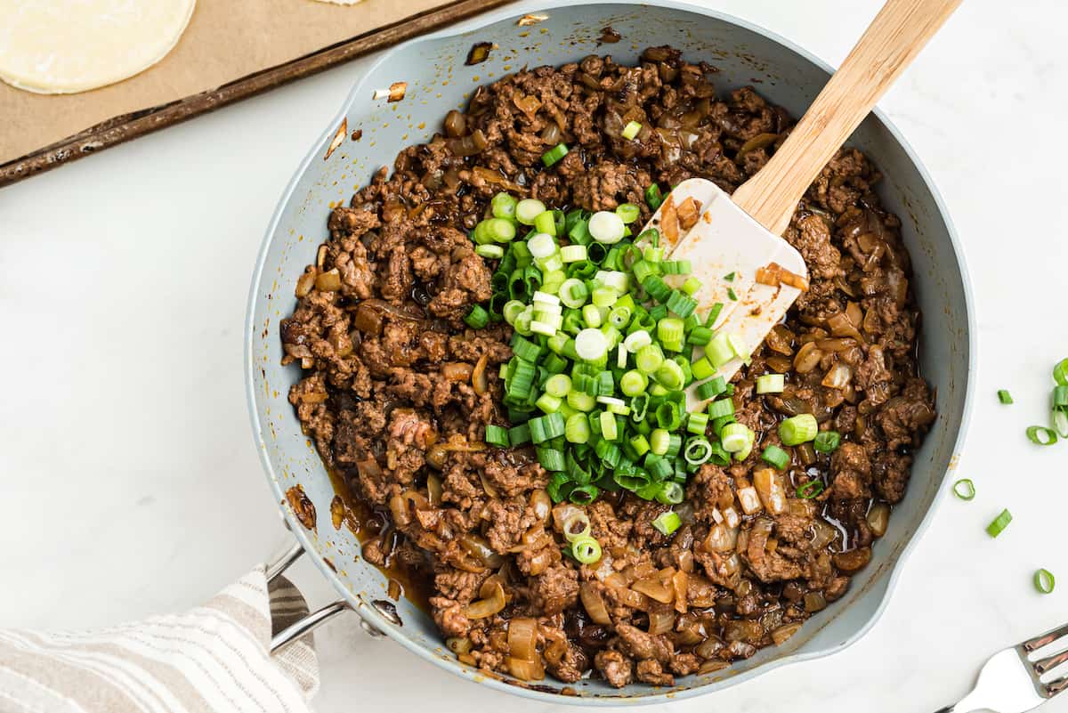add green onions to the ground beef and onions