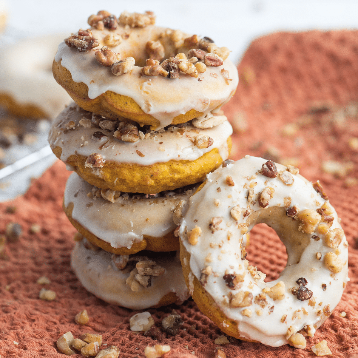 a stack of four Baked Pumpkin Spice Donuts with a fifth leaning against the rest