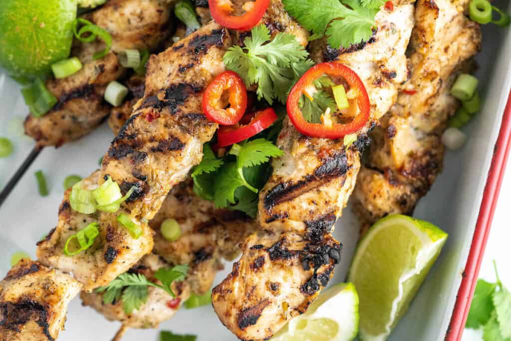 griled jerk chicken skewers with peppers and cilantro garnish