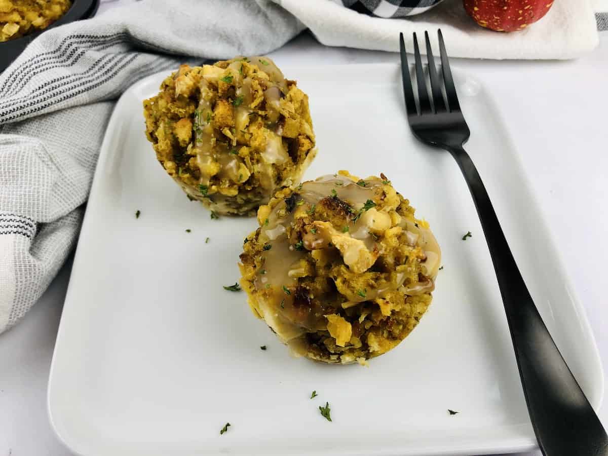 turkey and stuffing muffins on a plate with a drizzle of gravy