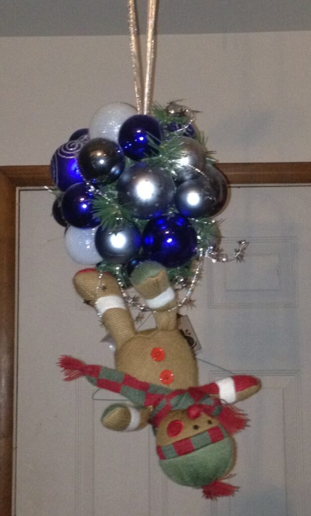 Elf on the Shelf hanging from Christmas ornaments