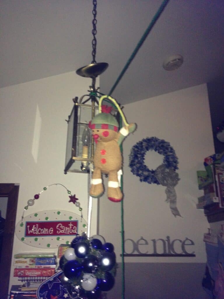 Elf on the Shelf on a zip line in the living room