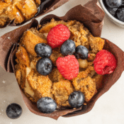 Cheesecake Stuffed French Toast Muffin Cups with fresh red raspberries and blueberries